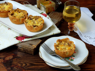 Baked mushroom casserolle with cheese in dough and glass of wine, french julienne. selective focus