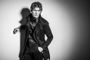 Studio picture of a young and handsome man posing isolated