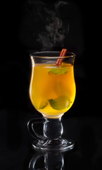 Hot steaming christmas mulled wine on black background