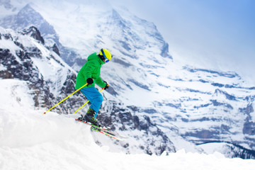 Naklejka na ściany i meble Child skiing in the mountains