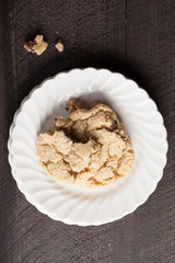 Homemade chocolate chip oatmeal cookies stacked with a bite taken out of one top view