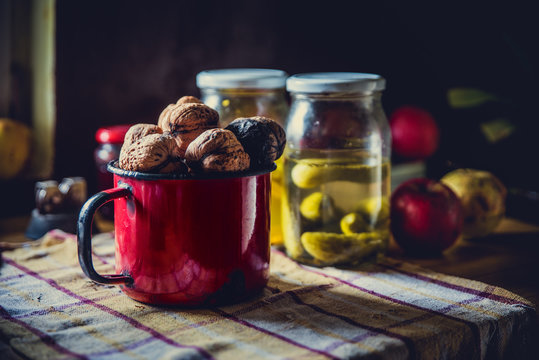 Red tin cup full of walnus