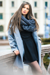 Cute girl stands on the background of building