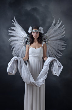 beautiful woman in white dress with angel wings