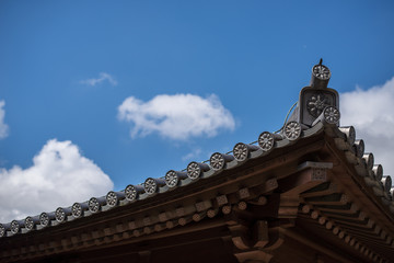 Buddhist temple roof tile and eaves with blue sky