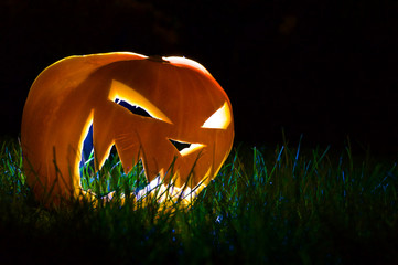 Halloween Pumpkin in grass at night