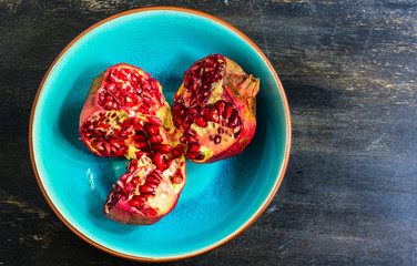 Obraz na płótnie Canvas Ripe pomegranate on wooden table