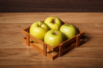 Green apples in the wooden basket