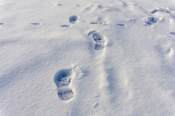 Snow texture with footprints. Concept of winter outdoor hiking