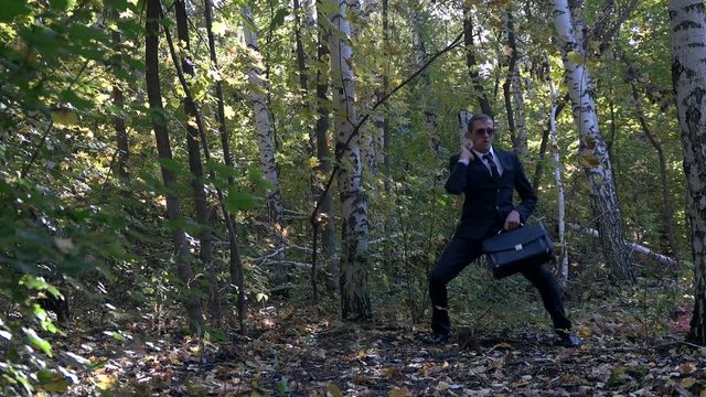businessman playing in the woods as a child