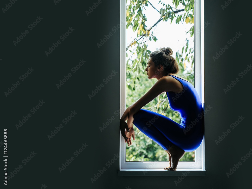 Wall mural pretty sexy sporty woman on window