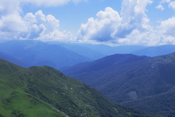 Naklejka premium Beautiful mountains view. Natural background. High in the mountains. Landscape with alpine meadows.