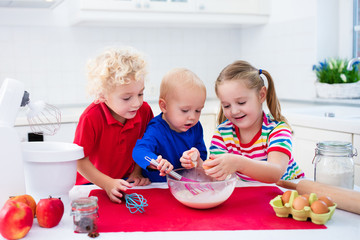 Kids baking a pie in white kitchen