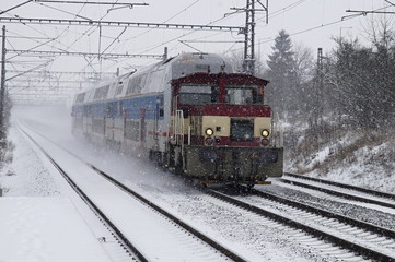 Fototapeta na wymiar Electric train in snow storm.