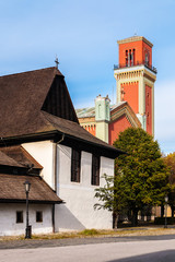 Fototapeta na wymiar Wooden articular and New red church in Kezmarok, Slovakia