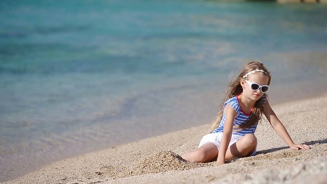 Adorable little girl on the beach during greek vacation
