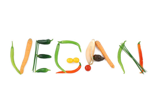 Word vegan written with vegetables, as a metaphor or concept for healthy food, living, diet, recipe. Isolated on white background