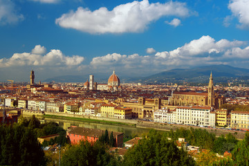 View of the beautiful medieval italian city and culture capital - Florence with cathedrals and bridges over river and blue cloudy sky. Travel outdoor sightseeing historical background.