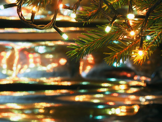 Christmas lights on Christmas tree, decorative garland on blurred background brilliant