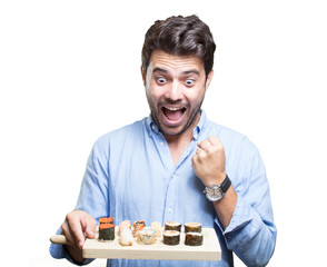 Young man eating sushi on white background