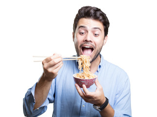 Young man eating sushi on white background