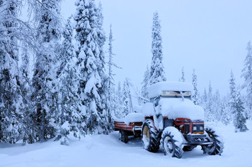 Tractor in winter forest