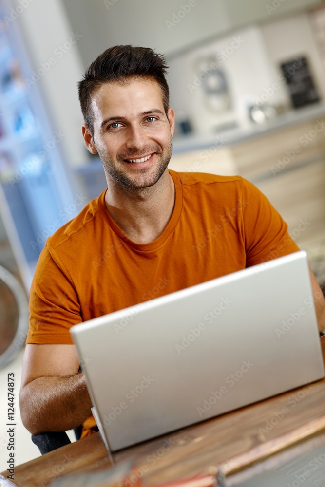 Sticker Handsome young man using laptop