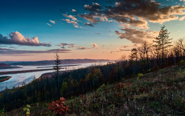 Sunset over the Amur river in late autumn. Autumn Evening on the river.