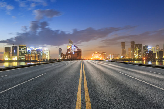 Asphalt roads and beautiful cityscape at dusk in Hangzhou