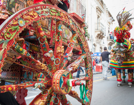 Close-up view of a colorful wheel of a typical sicilian cart during a folkloristic show