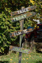 Homemade Halloween street sign decoration pointing the way to Trick, Treat, Elm Street and Zombies