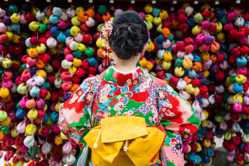 Woman dressed in kimono at colorful background, Kyoto, Japan