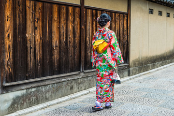 Fototapeta na wymiar asian woman wearing kimono walking on the old street, Kyoto Japan