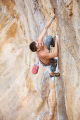 Male rock climber on a challenging route on a cliff