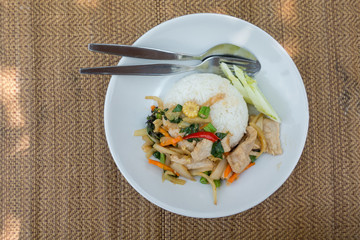 Stir-fried pork with basil leaves on jasmin rice, 
famous thai food