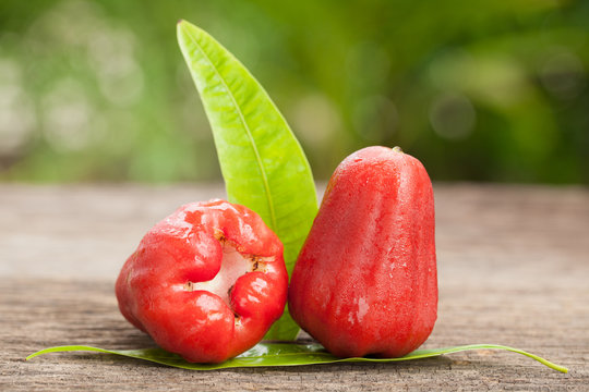 Beautiful rose apple and green leaf isolated on wooden, natural