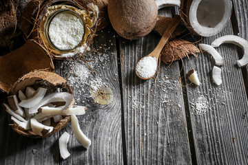 Fresh coconuts broken on wooden background
