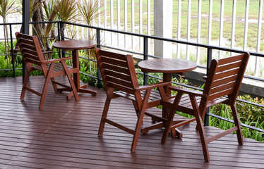 wooden table and chairs in the cafe. wooden chair and table at front porch. something on table in garden.