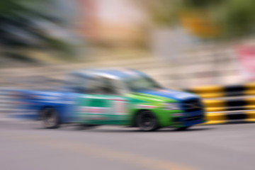 Race car racing on speed track with motion blur
