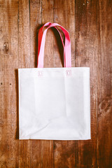 Paper shopping bag on the wooden background