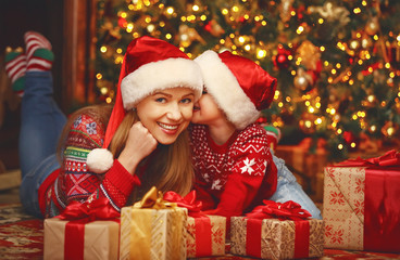 Fototapeta na wymiar Happy family mother and child girl with Christmas present