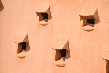 Array of small windows on an organic textured roof