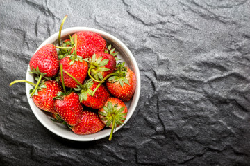 Fresh strawberries on black background
