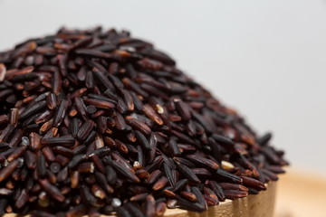 Rice Berry,Thai Jasmine rice on wood cup,Close-up shot.