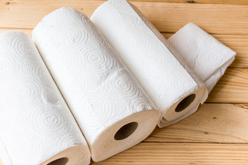 Roll of paper towel on wooden background
