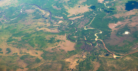 View from airplane on Earth surface - river. With some hot air effect.