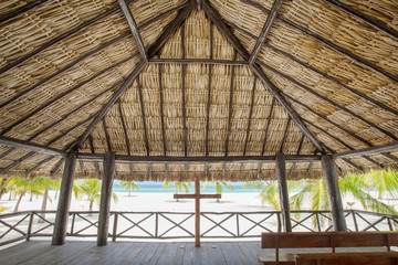 Fototapeta na wymiar View from tropical gazebo on the beach with palm trees