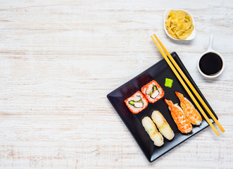 Sushi on Black Plate with Soy Sauce and Ginger on Copy Space