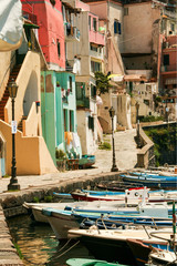 Fototapeta na wymiar the charming port of Corricella with its colorful fishermen's houses and boats, Island of Procida, Naples, Italy