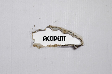 The word accident appearing behind torn paper